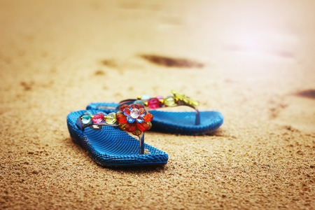 Beach flip flops on tropical sandy coast. Holiday concept.の写真素材