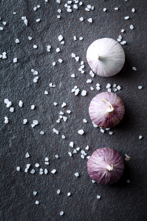 Food background with garlic on dark stone. Top view.の写真素材