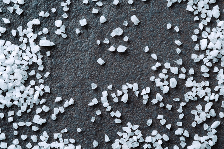 Background with salt grains close-up on stoneの写真素材
