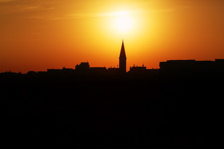 Skyline of a town of Akko, Israel old sea port at the sunset with Catholic towersの写真素材
