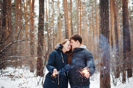 Couple in love having fun in winter holidays. Snow forest.の写真素材