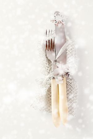 Christmas table setting. Vintage silverware with Christmas decorations over white. Selective focus.の写真素材