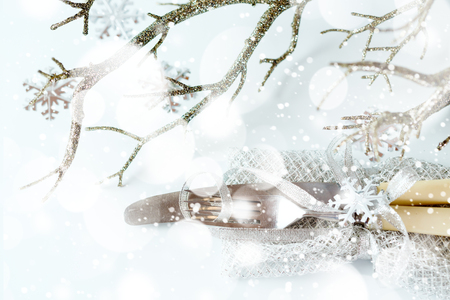 Christmas table setting. Vintage silverware with Christmas decorations over white. Selective focus.の写真素材