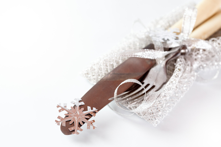 Christmas table setting. Vintage silverware with Christmas decorations over white. Selective focus.の写真素材