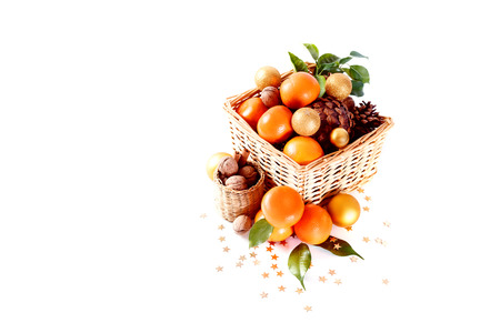 Christmas composition with tangerines, cones, walnut, and decorations over white background. Holiday greeting card.の写真素材