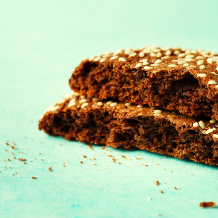 Close-up of cracked into two halves chocolate cookie with sesameの写真素材