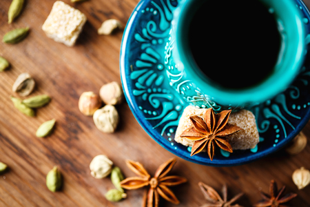 Hot drink with spices in authentic eastern arabic dish, masala chai or spiced tea or hot mulled wine, top view, selective focusの写真素材