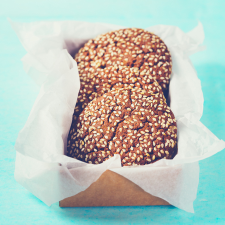 Chocolate oat cookies in craft paper, close-up composition, image tonedの写真素材
