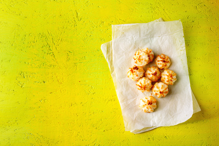 Little coconut cookies on bright yellow background. Top view, copy space.の写真素材