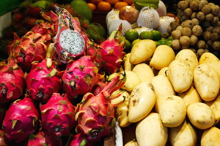 Fruit market in Thailand, exotic street food, mango and dragon fruitの写真素材