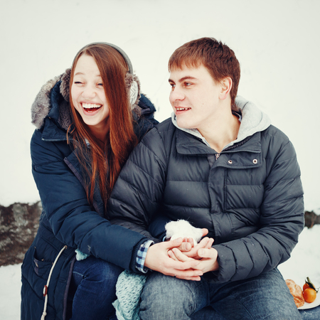 Loving couple having fun and laughing outdoors in winter rural weekend の写真素材