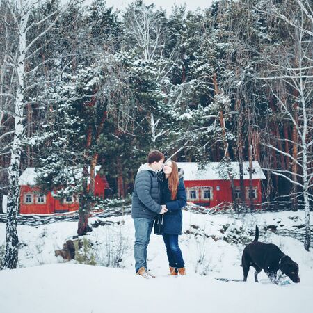 Young loving couple having fun in winter forest, winter vacation concept, tonedの写真素材