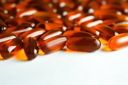 Gel capsules scattered on white background, selective focus, copy spaceの写真素材