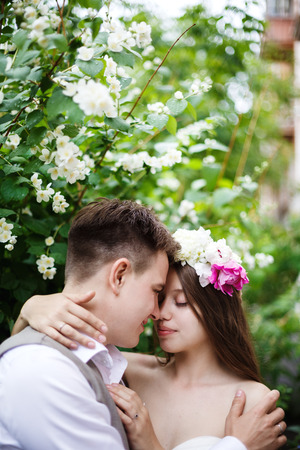 Happy just married  couple in the summer park, embracing and kissingの写真素材