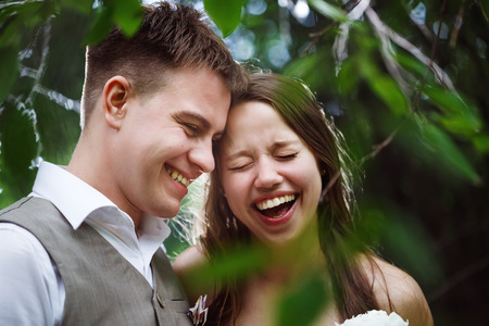 Happy wedding couple laughing in the park, headshotの写真素材