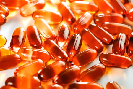 Gel capsules scattered on white background, top view, selective focusの写真素材