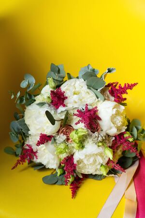Wedding flowers close-up on bright yellow backgroundの写真素材