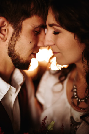 Beautiful loving couple kissing. Close-up portrait of wedding couple. Selective focus.の写真素材