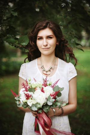 Freedom woman concept. Boho chic style. Bridal with wedding flowers, hair and ribbons blowing in the wind.の写真素材