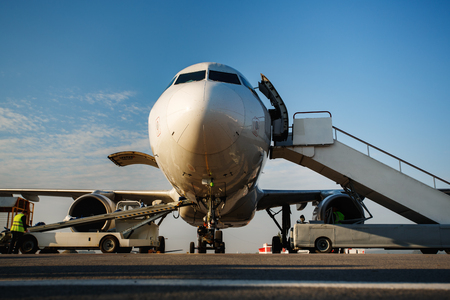 Preflight service, aircraft maintenance, baggage is loading into the luggage compartment of the aircraft at the airportの写真素材