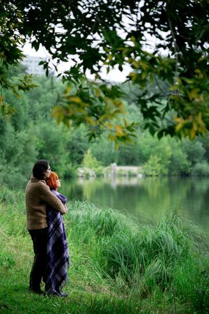 Romantic loving couple resting at the nature near waterの写真素材