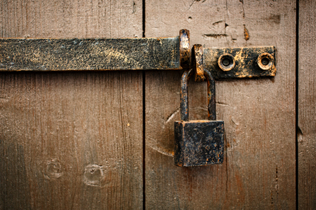 Old rusty aged padlock on the door outsideの写真素材