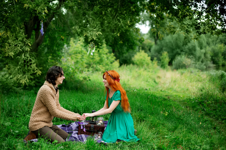 Young couple resting at the nature outdoors, picnic, couple holding handsの写真素材