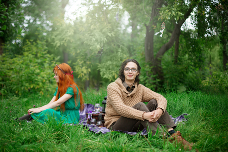 Young couple resting at the nature outdoors, picnic, selective focus on manの写真素材