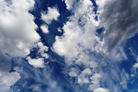 High dark blue sky with clouds, cloudscape, nature background の写真素材