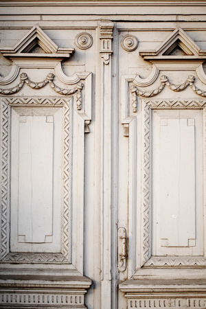 Background with old doors with carved ornamentの写真素材