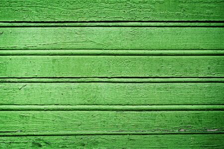 Horizontal colored planks, green shabby wooden backgroundの写真素材