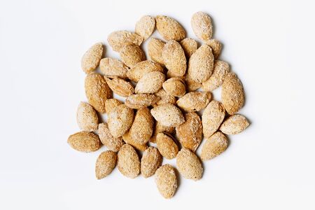 Heap of roasted almond nuts on white backgroundの写真素材