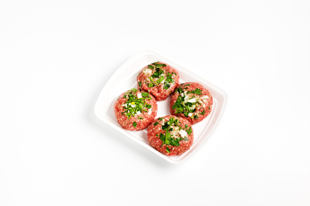 Raw food, beef cutlet ready for prepare. Minced meat in plastic box on white background.の写真素材