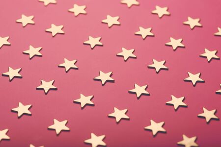 Pinky holiday background with golden stars, festive concept, close-upの写真素材