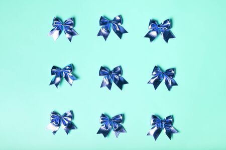 Blue celebration background with bows. Festive present concept, flat lay.の写真素材