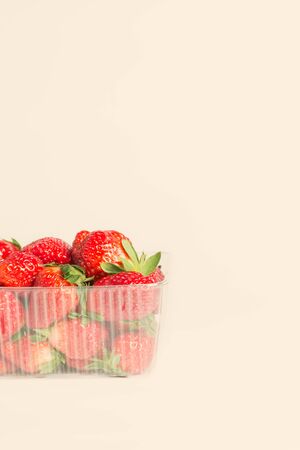 Fresh red strawberries in plastic transparent packageの写真素材
