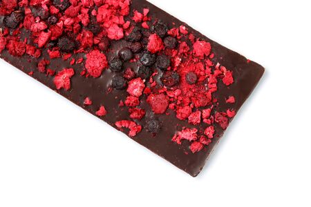Handmade dark chocolate bar with dried berries isolated on white background, view from above