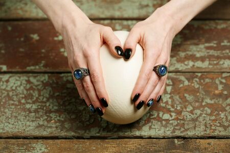 Manicured woman`s hands, nail art and jewelry with dragon`s eyes, fantasy syleの写真素材