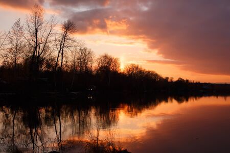 Serene sunset on the river in rural land, tranquil sceneの写真素材