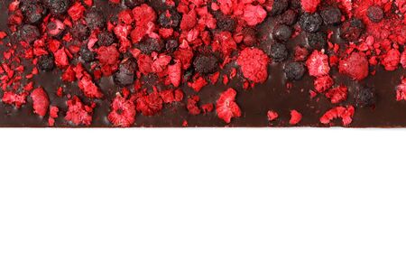 Handmade dark chocolate bar with dried berries isolated on white background, view from above, copy spaceの写真素材
