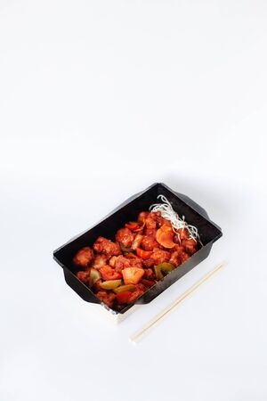 Chicken pieces with red paprika in sour-sweet sauce, ready-to-eat traditional chinese food, menu of delivery serviceの写真素材