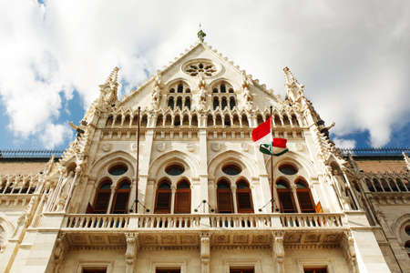 BUDAPEST, HUNGARY - July 23, 2019 - View on facade of Hungarian parliament building with flag, famous touristic destination in Budapestのeditorial素材