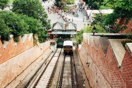 BUDAPEST, HUNGARY - July 23, 2019 - View from the Buda castle on the funicular and historical cable care and square with touristsのeditorial素材