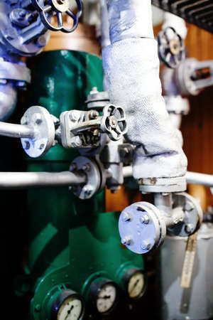 Old aged gray pipes and valves close-up