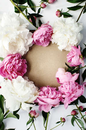 Simple flat lay flower frame of pink and white peonies, spring and summer season conceptの写真素材