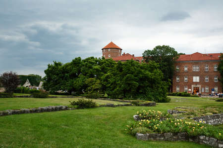 KRAKOW, POLAND - July 21, 2019: Brick building of Wawel castle residency in public park area, the first UNESCO World Heritage Site in the worldのeditorial素材