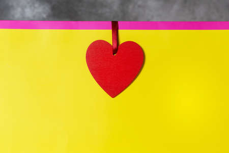 Valentines day present mockup in bright colors pink and yellow with red heart-shaped tag