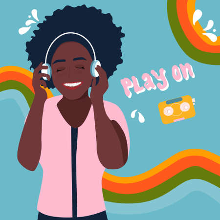 Young afro american woman in headphones listening to lovely music and smiling.Let the music play on....