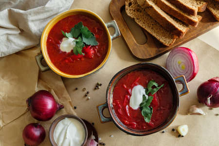 Two plates of soup borscht on a beige background flat lay