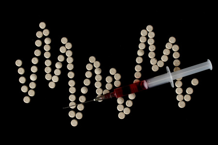 Multicolor medicine hypodermics on black background. Healthcare, addiction.の写真素材